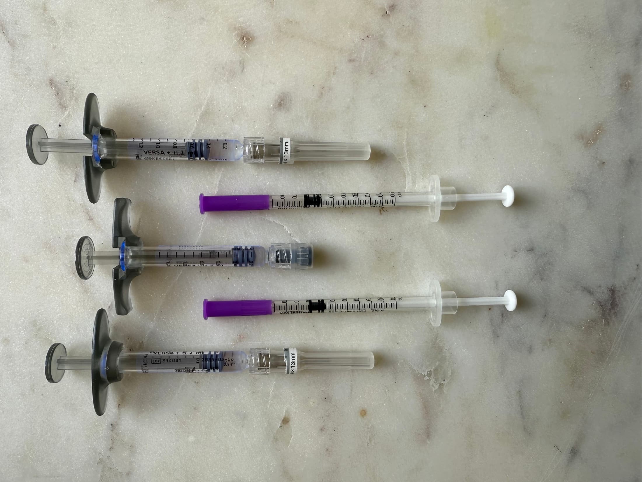 Dermal filler and wrinkle relaxer syringes laid out side by side at SEA Medical Wellness